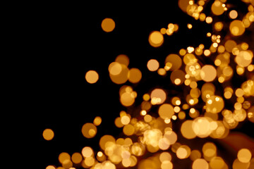 Abstract glitter defocused blinking christmas sparks on black background. Christmas and New Year holidays template