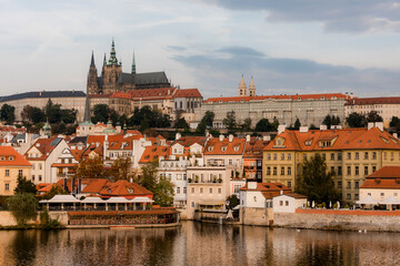 View of the city of Prague with St. Vitus Cathedral on the hill and the Vltava river at dawn