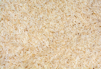 Pile of brown color rice texture background.
