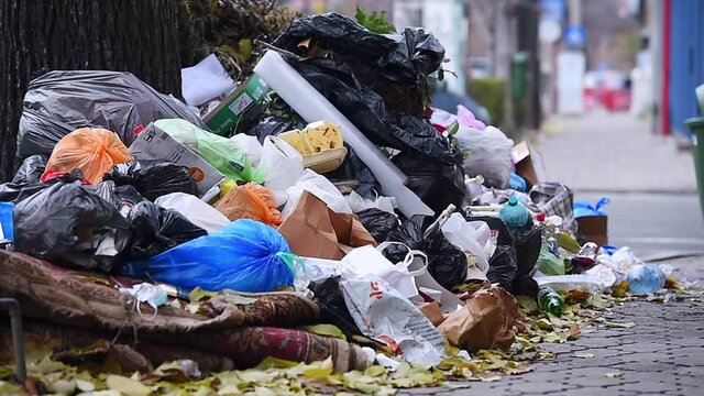 Piles of household waste are abandoned on the streets of Bucharest