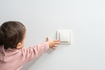 Little child playing with switch
