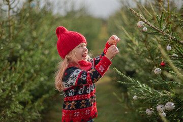 girl with long blond hair in the woods Christmas tree