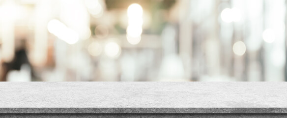 Empty white marble stone table top and blur interior cafe and restaurant.