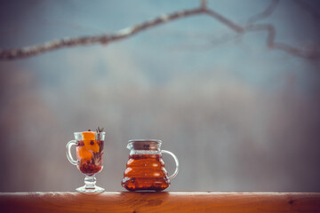 Hot tea in a glass pot and cup