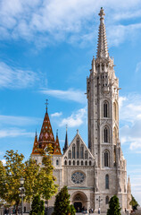 Fototapeta na wymiar View of the 13th century St. Matthias Church with gothic bell tower in Budapest, Hungary. It is also known as Church of the Assumption of the Buda Castle, or Coronation Church of Buda