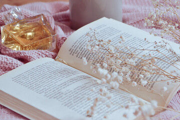 book with flowers and parfume