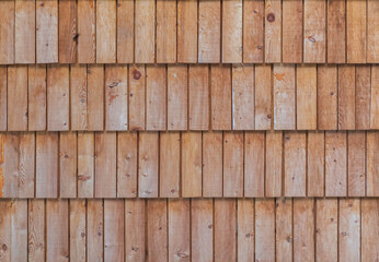 Wooden background. House wall sheathed with larch boards