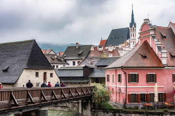 Obraz premium Houses and Cathedral of Cesky Krumlov, Czech Republic, in foggy weather