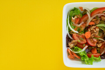salad plate on yellow background. Healthy vegetarian food. Space for text
