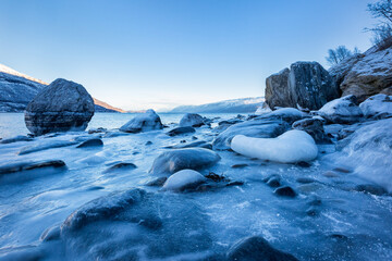 Beautiful winter landscape with icy shore of the fjord