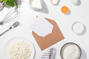 Cottage cheese, eggs, sugar, cream and yougurt on a white background - Flat lay with letter - Space for text