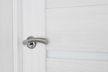 Metallic door knob on a home wooden door