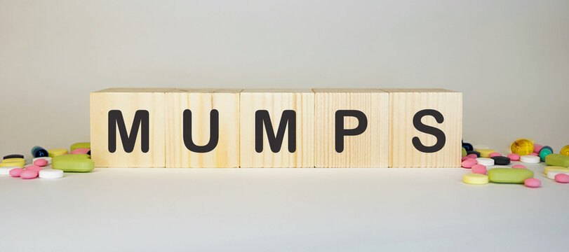 MUMPS word on cubes surrounded with pills Medicine concept