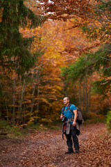 Nature photographer shooting fall scene in the forest