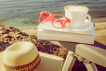 Coffee cup and book outdoors