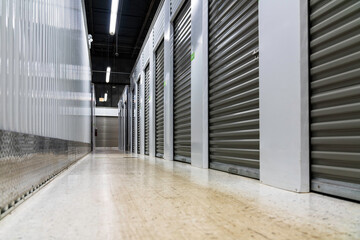 Storage warehouse interior. Metal garage doors with locks. Low angle view