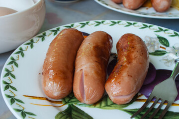Grilled sausages. Closeup of sausage on the grill. Home-made Sausages. Bavarian sausages