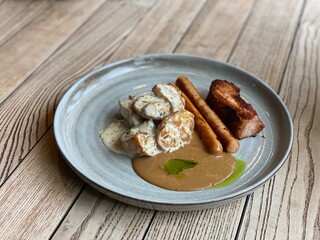 meat, sausages and potatoes with sauce