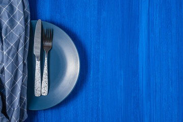 table knife and fork on a blue background.