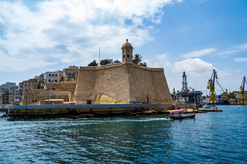 A water taxi passes the Spur bastion at the tip of city of Senglea in Malta.