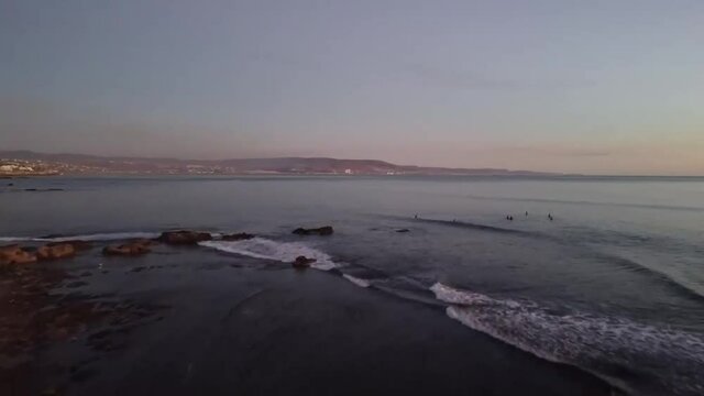 Aerial view of surfers in mexico during beautiful sunset