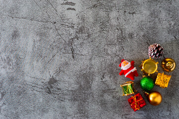 Flat lay view of Christmas decoration objects over concrete gray backdrop with copy space