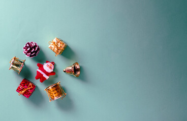 Flat lay view of Christmas decoration objects over isolated green with copy space and minimal looking