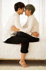 Fototapeta na wymiar Asian men same sex love marriage LGBTQ on bed during holiday having good time. 