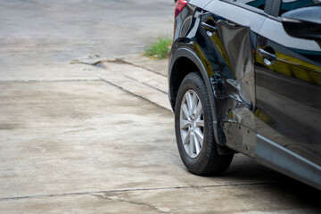 Body of black suv car damaged by car accident on the road.