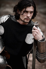 Knight in armor and with a sword. Medieval warrior