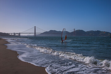 Surfer at Golden Gate Bridge and San Francisco Bay