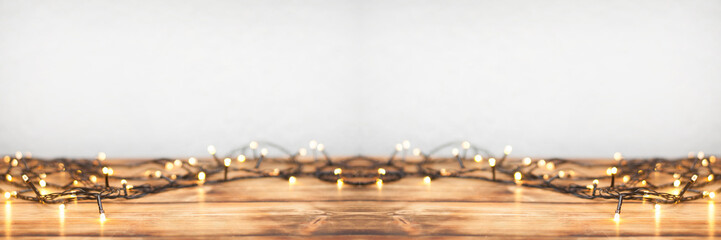 Garland lights on a wooden background. Defocused festive background.