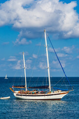 Sailing boat moored on a calm sea in St. Julians Bay, Malta