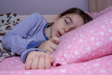 Bed time for kids. Cute little girl sleeping. Sleepy toddler girl sleeping on her bed.