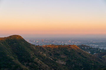 a view of the hollywood mountains during golden hour in los angeles, california