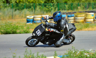 Motorcycle practice leaning into a fast corner on track