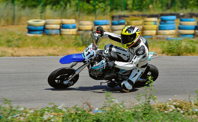 Motorcycle practice leaning into a fast corner on track