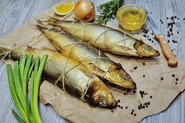 smoked fish mackerel or scomber on a white parchment paper, close-up, top view