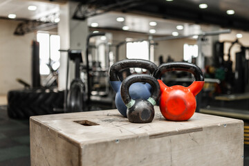 Functional training equipment. Kettlebells on a wooden box in modern gym