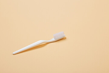 white toothbrush on beige background