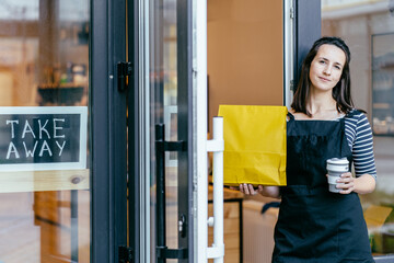 Concept of ecological and recycled zero waste lifestyle. Sustainability, zero-waste, world peace concept. Woman owner with face mask serving coffee in reusable silicone cup stands in doorway of plasti