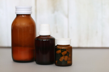 brown bottle with cough syrup on background