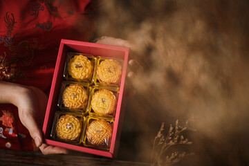 Box of Mooncake a Chinese traditional pastry for Mid-Autumn festival. set on rustic wooden table.