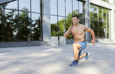 Young athletic man doing warm-up before outdoor workout. Healthy lifestyle. Fitness concept