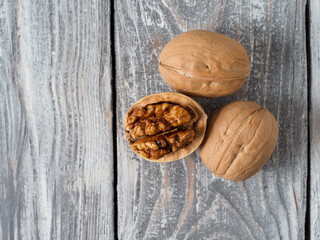 Walnut with shell on wooden background.