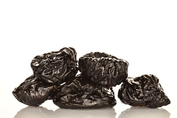 Sweet organic prunes, close-up, on a white background.