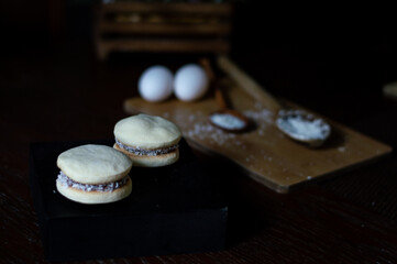 Uruguayan and Argentinian alfajor in dark scenery. Typical South American food. Chocolate cake with dulce de leche filling. Uruguay. Argentina