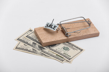 Mousetrap with sale bait with dollar bills on white background. Trap or deception concept