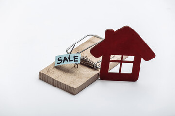 Mousetrap with sale bait and house on white background. Trap or deception concept