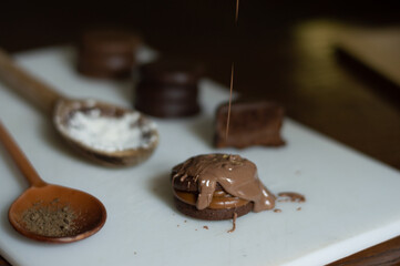 Uruguayan and Argentinian alfajor in dark scenery. Typical South American food. Chocolate cake with dulce de leche filling. Uruguay. Argentina